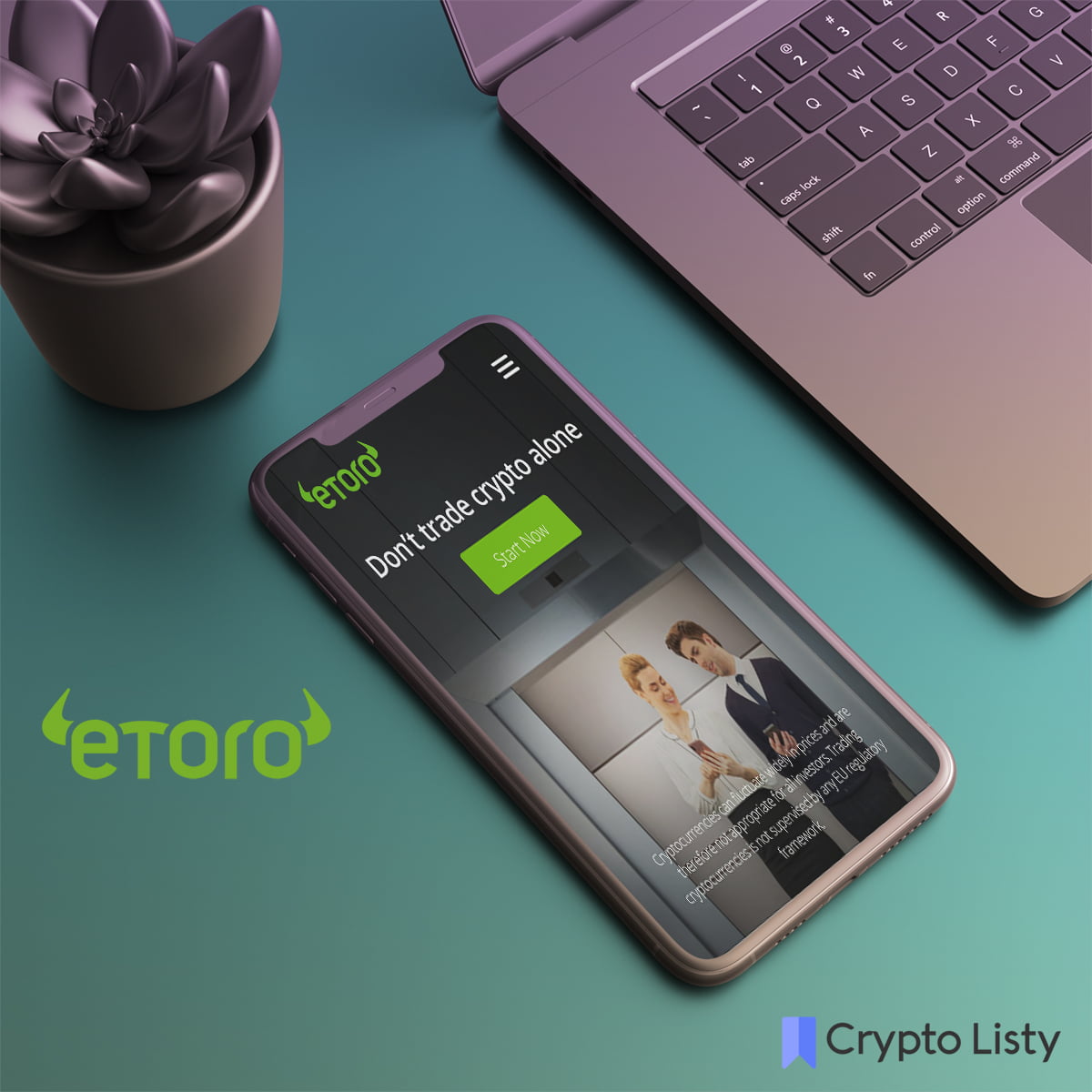 Phone next to a laptop and phone is browsing eToro website.